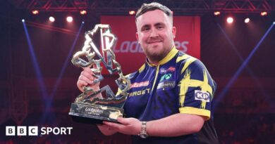 Luke Littler holds the UK Open trophy