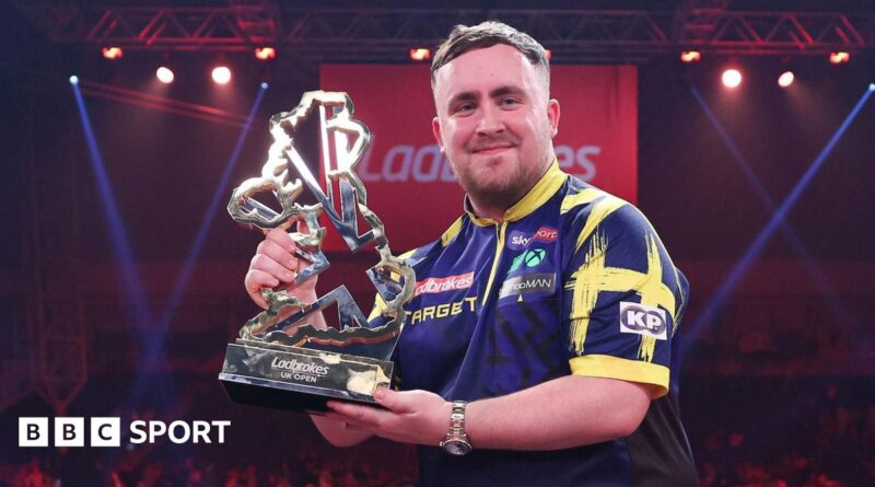 Luke Littler holds the UK Open trophy