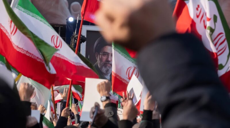 Iranian men shout anti-U.S. and anti-Israeli slogans in front of a portrait of Iran's new Supreme Leader, Ayatollah Mojtaba Khamenei, the son of the late Leader Ayatollah Ali Khamenei, during a rally to pledge allegiance to Mojtaba Khamenei amid the U.S.-Israeli military campaign in Tehran, Iran, on March 9, 2026.