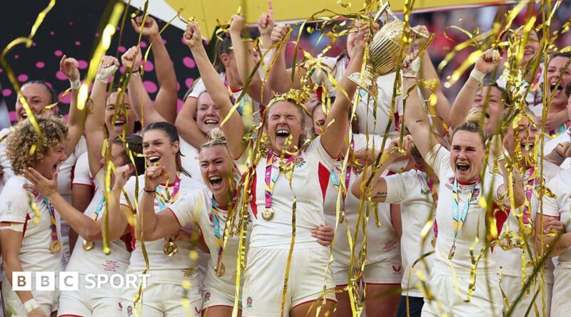 Zoe Aldcroft of England lifts the Women's Rugby World Cup trophy after defeating Canada