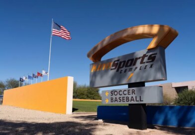 The American flag flutters near a sign pointing to the soccer stadium at Kino Sports Complex, where the Iranian men’s soccer team is scheduled to practice for the FIFA World Cup, in Tucson, Arizona