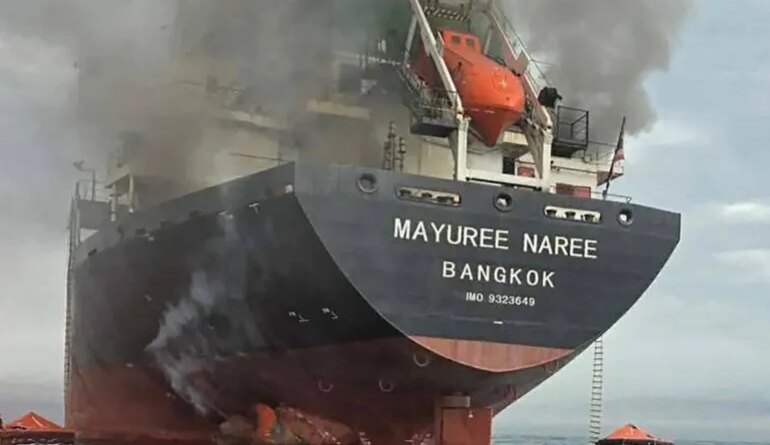 This handout photo taken on March 11, 2026 and released by the Royal Thai Navy shows smoke rising from the Thai bulk carrier 'Mayuree Naree' near the Strait of Hormuz after an attack. A Thai bulk carrier travelling in the crucial Strait of Hormuz was attacked March 11, with 20 crew members rescued so far, the Thai navy said. (Photo by Handout / ROYAL THAI NAVY / AFP) / -----EDITORS NOTE --- RESTRICTED TO EDITORIAL USE - MANDATORY CREDIT "AFP PHOTO / ROYAL THAI NAVY " - NO MARKETING - NO ADVERTISING CAMPAIGNS - DISTRIBUTED AS A SERVICE TO CLIENTS -