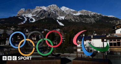 A picture showing the logo of Milano Cortina 2026 Olympic and Paralympic Games with the Women's Alpine skiing Olympia delle Tofane slope in the background in the distance in Cortina d'Ampezzo.