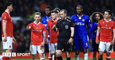 Lewis O'Brien of Wrexham speaks to Referee Peter Bankes as a VAR review takes place