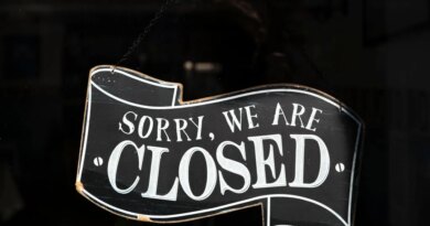 A closed sign in the window of a small business