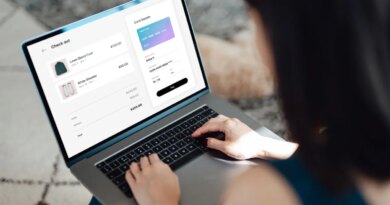 Above the shoulder view of a young Asian woman shopping clothes online on laptop, making payment with credit card. Enjoying seasonal sales. Shopaholic concept. Cyber security idea. Close up shot. Laptop screen mockup.