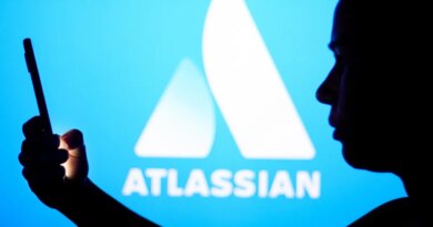 an Atlassian logo on a blue background with a person silhouetted in front holding a phone, for some reason