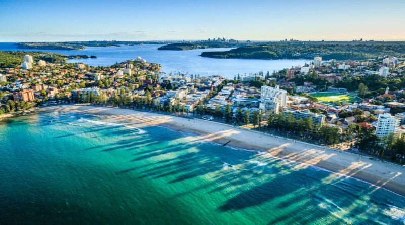 Aerial view of Sydney cityscape with ocean in foreground