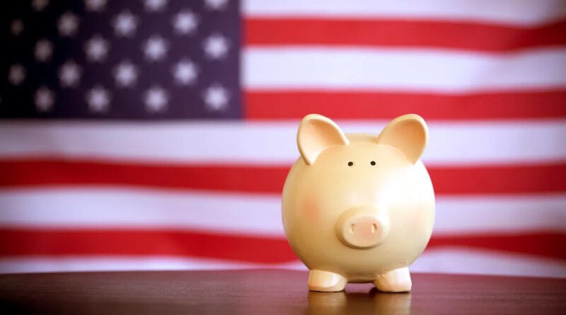piggy bank in front of american flag. government spending in tech