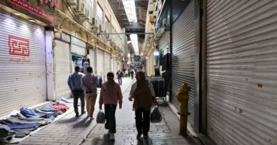 People walk past closed shops at the Grand Bazaar in Tehran, Iran on March 30, 2026.