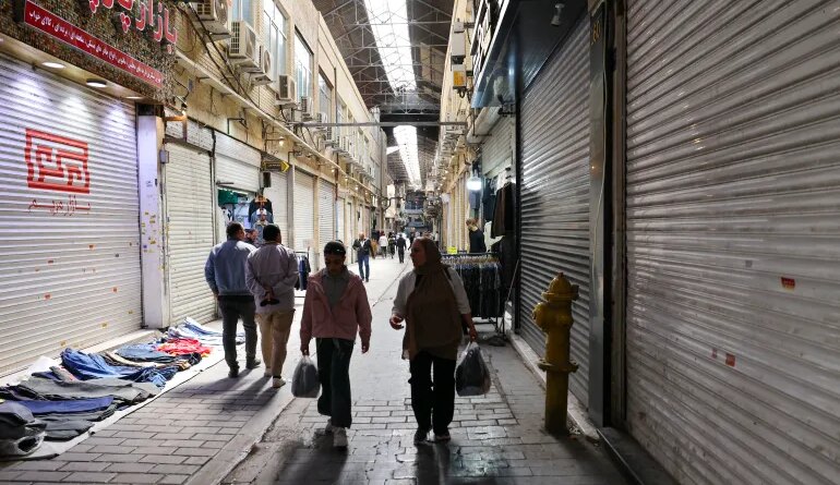People walk past closed shops at the Grand Bazaar in Tehran, Iran on March 30, 2026.