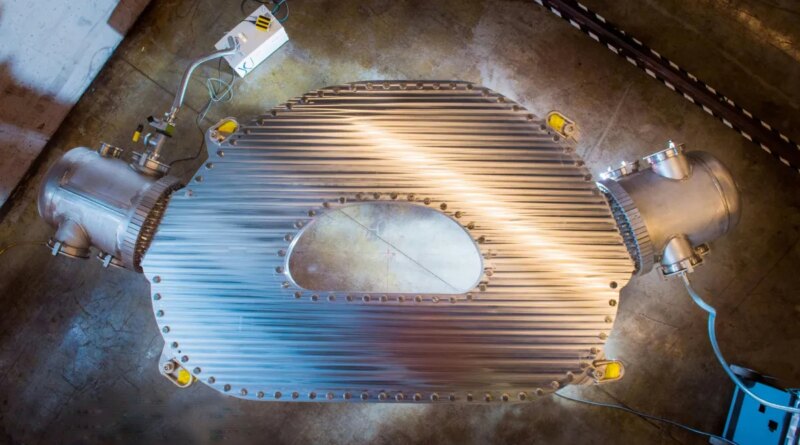 A large HTS magnet sits on the floor of a warehouse.