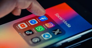 finger pointing to Facebook mobile app displayed on a smartphone screen