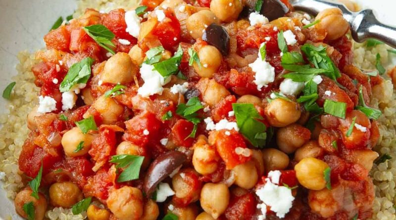 Chickpea stew with tomatoes, olives and quinoa in a bowl.