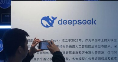 A man takes photos of a DeepSeek display at a shopping mall in Hangzhou