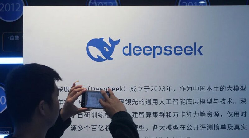 A man takes photos of a DeepSeek display at a shopping mall in Hangzhou