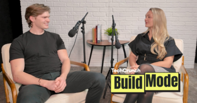 Artisan CEO, Jaspar Carmichael-Jack and Build Mode host Isabelle Johannessen sit facing each other in a podcast studio with microphones, mid-conversation, in front of a white brick wall; a small table with books and a plant sits between them, and a “TechCrunch Build Mode” logo overlay appears in the lower right corner.