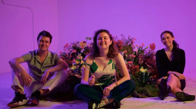 3 young adults sitting with AI gadgets