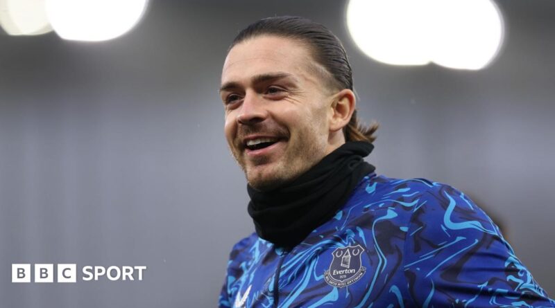 Jack Grealish poses for a photo with five athletes from Special Olympics Great Britain. They are all holding up Everton shirts with '26.2' on.