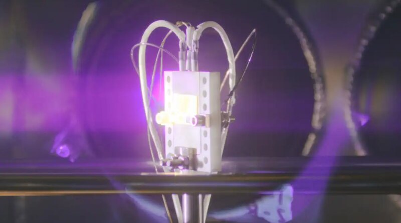 A radiovoltaic material glows under bombardment by alpha particles.