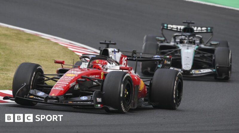 Ferrari's Charles Leclerc goes around a right-hand corner during the Japanese Grand Prix with Mercedes' George Russell right behind him
