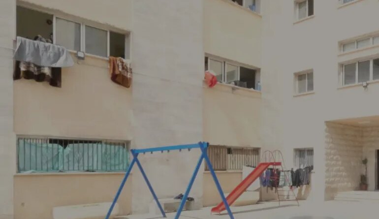Vacant swings and slides at a school in the Lebanese Mountains.