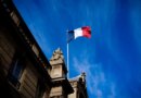 French tricolour flag (blue, white and red, symbol of the Republic of France) hanging from a flagpole above the entrance gate to the courtyard of the Elysee Palace, Exit from the Cabinet meeting at the Presidential Palace of the Elysee in Paris, France on August 27, 2025. The ministers get into their cars and leave the Elysee Palace. (Photo by Amaury Cornu / Hans Lucas via AFP)