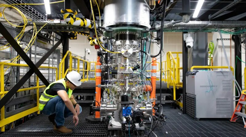 A worker inspects Zap Energy's Fusion reaction chamber.