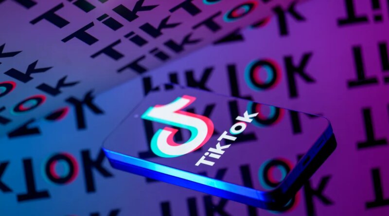 The TikTok logo is displayed on a smartphone screen in this photo illustration.