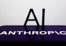 AI sign displayed on a screen and Anthropic logo displayed on a phone screen are seen in this illustration photo.