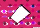 spyware illustrated; blank smartphone screen over a pink background of multiple eyes