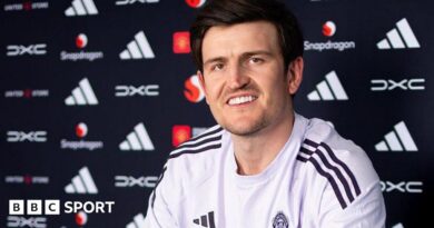 Harry Maguire smiling in a Manchester United news conference