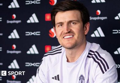 Harry Maguire smiling in a Manchester United news conference