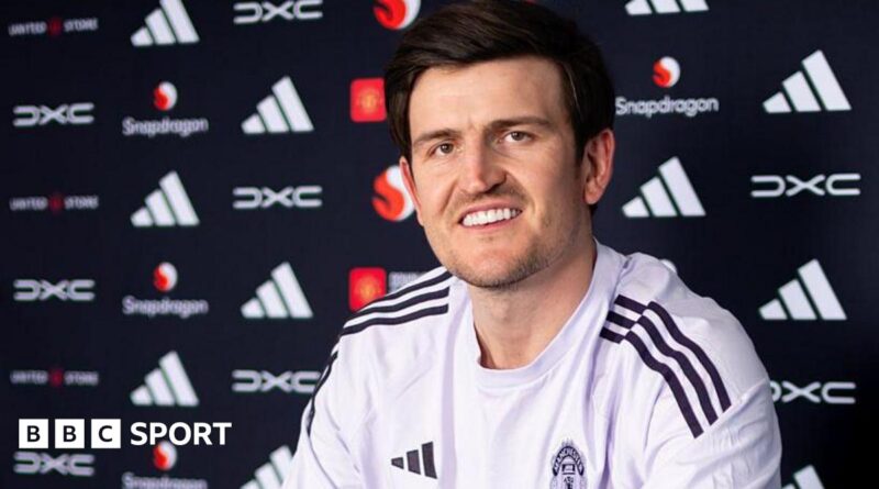 Harry Maguire smiling in a Manchester United news conference