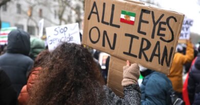 BERLIN, GERMANY - JANUARY 24: A protester holds a banner reading "All eyes on Iran" as people march in a demonstration held under the motto "Help Iran. No Business With The Mullahs" on January 24, 2026 in Berlin, Germany. Iranian officials have acknowledged that over 5,000 people were killed in the recent nationwide street demonstrations following violent suppression by government forces. (Photo by Omer Messinger/Getty Images)
