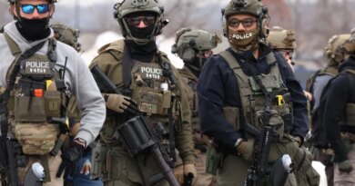 US Homeland Security Investigations (HSI) agents stand guard at the Bishop Henry Whipple Federal Building in Minneapolis, Minnesota, on January 8, 2026.