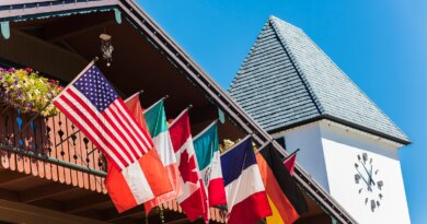 Clock Tower and Chalet Building with Flags in Vail, Colorado