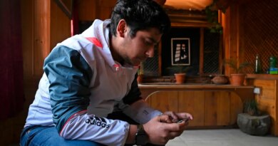 seated man looking at ell phone