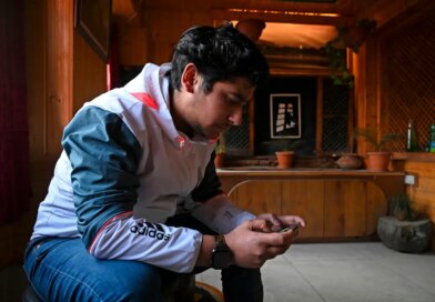 seated man looking at ell phone