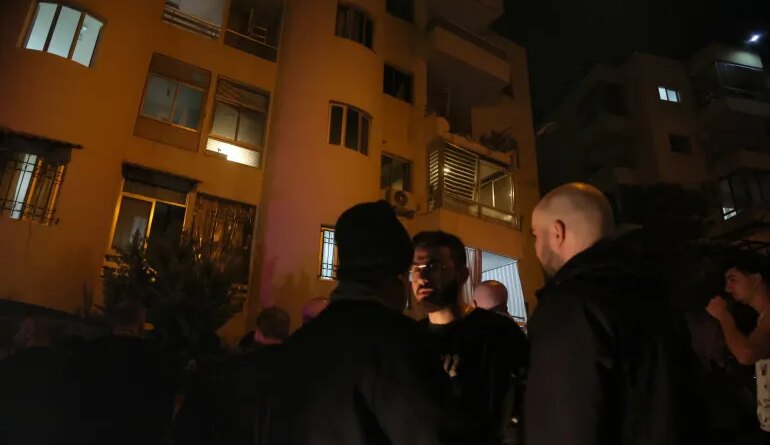 People gather at the site of an Israeli strike that targeted an apartment in the town of Ain Saadeh east of Beirut on April 5, 2026.