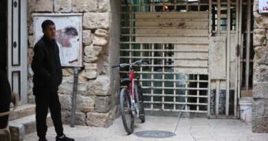 Man stands next to a barrier