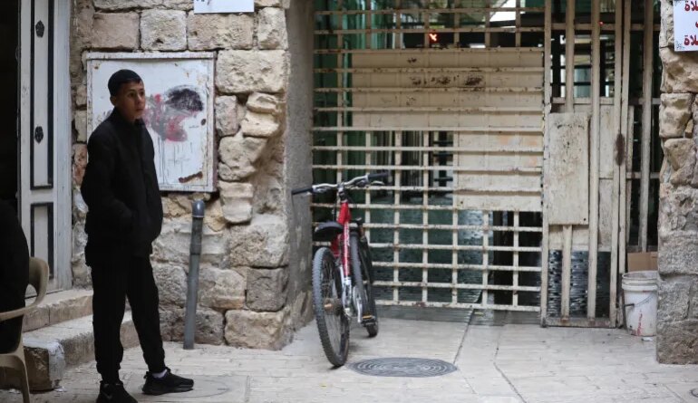 Man stands next to a barrier