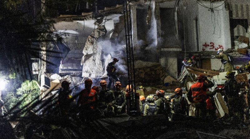 Israeli rescuers search for missing in building strike, two dead
