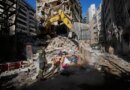 A Lebanese civil defense worker looks on as an excavator operates on the rubble of a building destroyed in an Israeli airstrike a day earlier in Beirut, Lebanon, Thursday, April 9, 2026. (AP Photo/Hussein Malla)