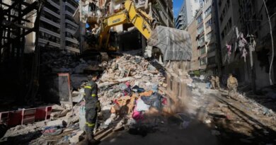A Lebanese civil defense worker looks on as an excavator operates on the rubble of a building destroyed in an Israeli airstrike a day earlier in Beirut, Lebanon, Thursday, April 9, 2026. (AP Photo/Hussein Malla)