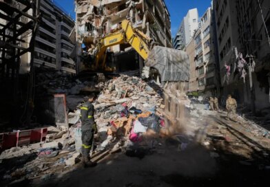A Lebanese civil defense worker looks on as an excavator operates on the rubble of a building destroyed in an Israeli airstrike a day earlier in Beirut, Lebanon, Thursday, April 9, 2026. (AP Photo/Hussein Malla)
