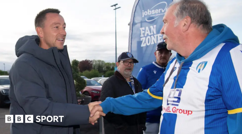 John Terry shakes hands with a Colchester fan