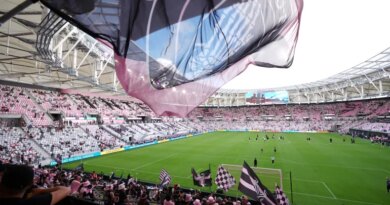 Inter Miami fans wave flags in Nu Stadium ahead of the team's first MLS soccer match in their new home stadium, against Austin FC, Saturday, April 4, 2026, in Miami. (AP Photo/Rebecca Blackwell)