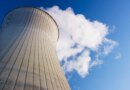 Cooling tower at nuclear power plant emits steam.