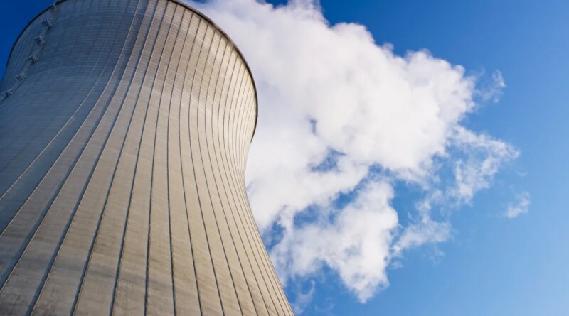 Cooling tower at nuclear power plant emits steam.